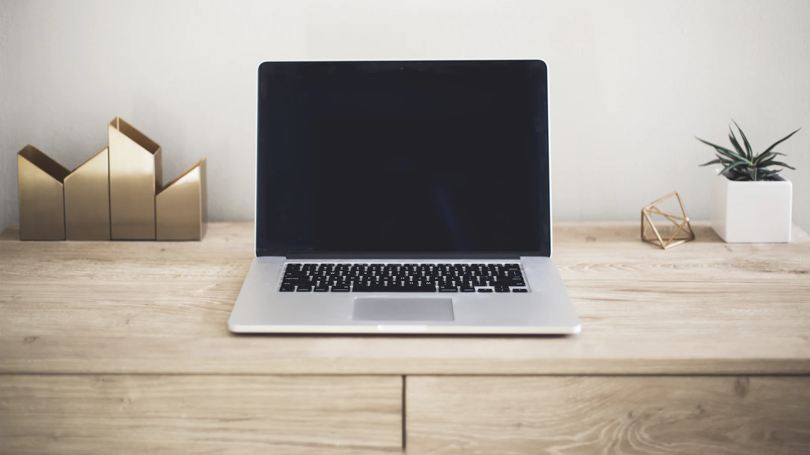 Laptop on a tidy wooden desk