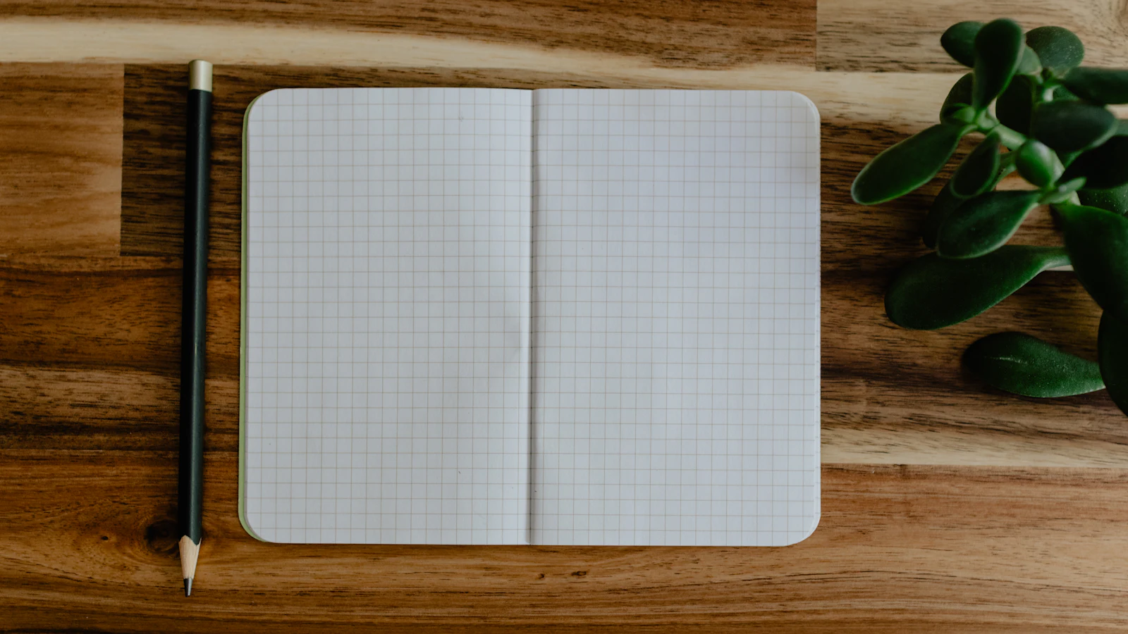Blank grid notebook on a wooden desk