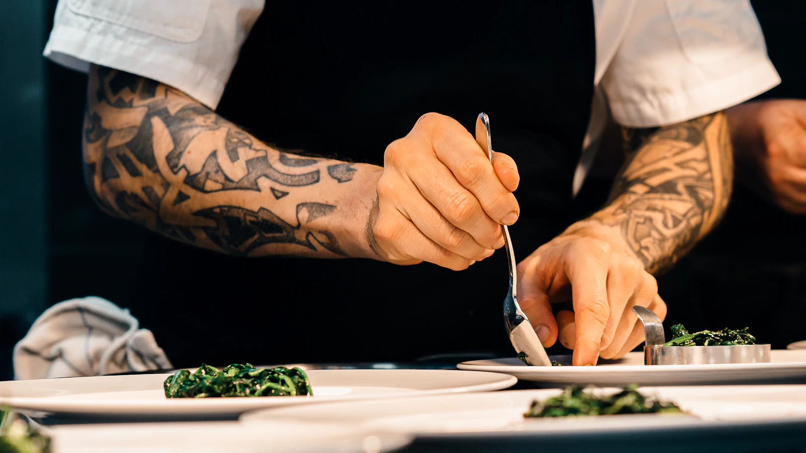 Chef plating a dish in a restaurant kitchen