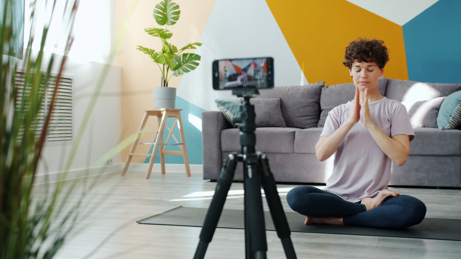 Woman filming a short video of herself with a phone on a tripod
